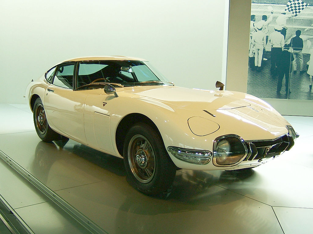 1967 Toyota 2000GT in white, low-slung coupe with pop-up headlights